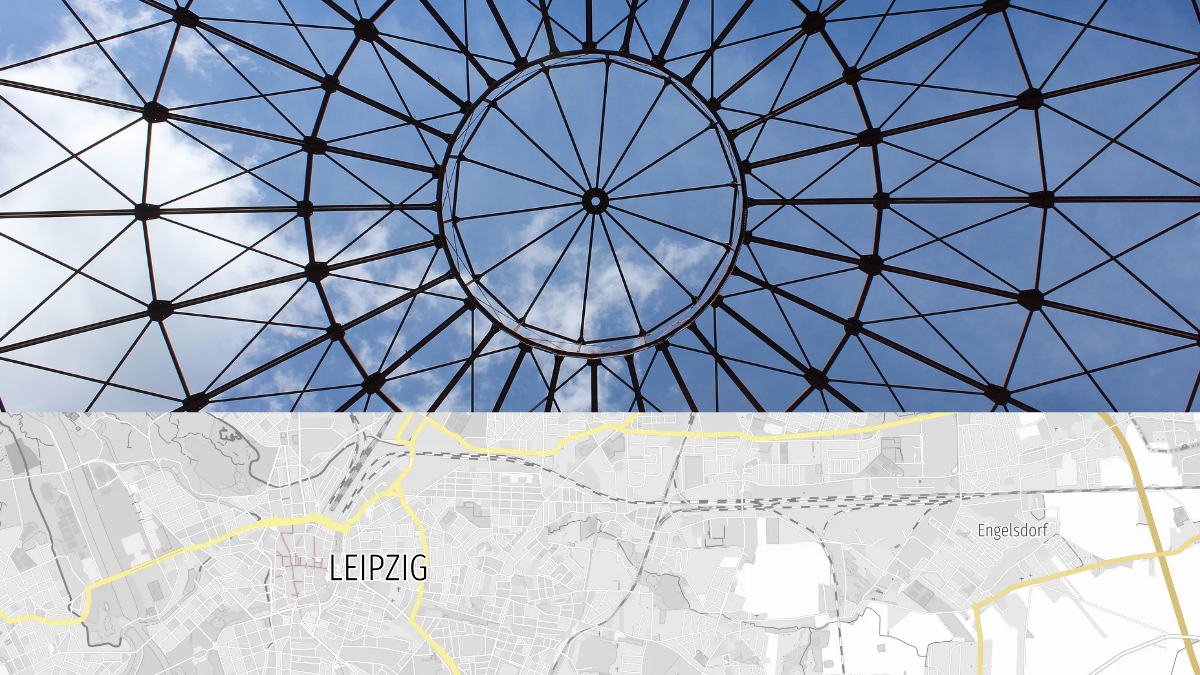 Geometrische Metallstruktur vor blauem Himmel mit darunterliegender Stadtkarte von Leipzig